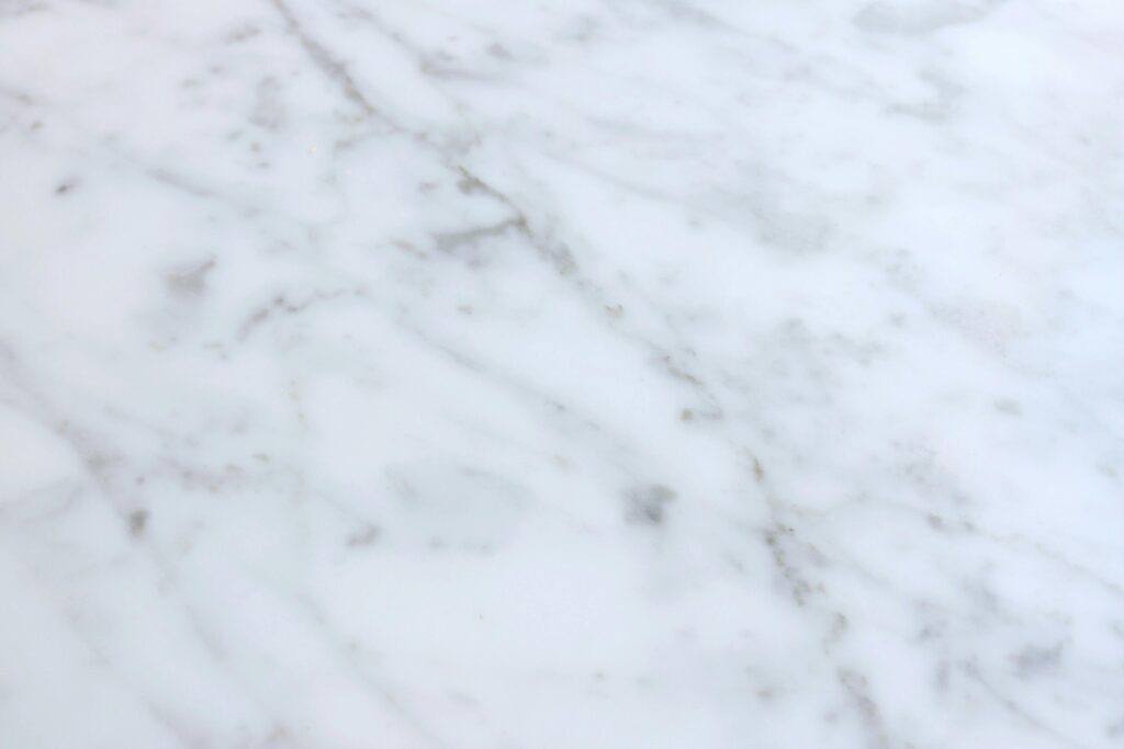 High-resolution white marble texture ideal for backgrounds, featuring smooth and classic design elements.